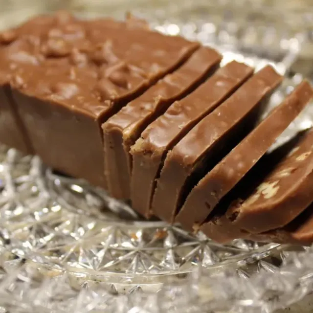 Chocolate pecan fudge, sliced on a crystal plate